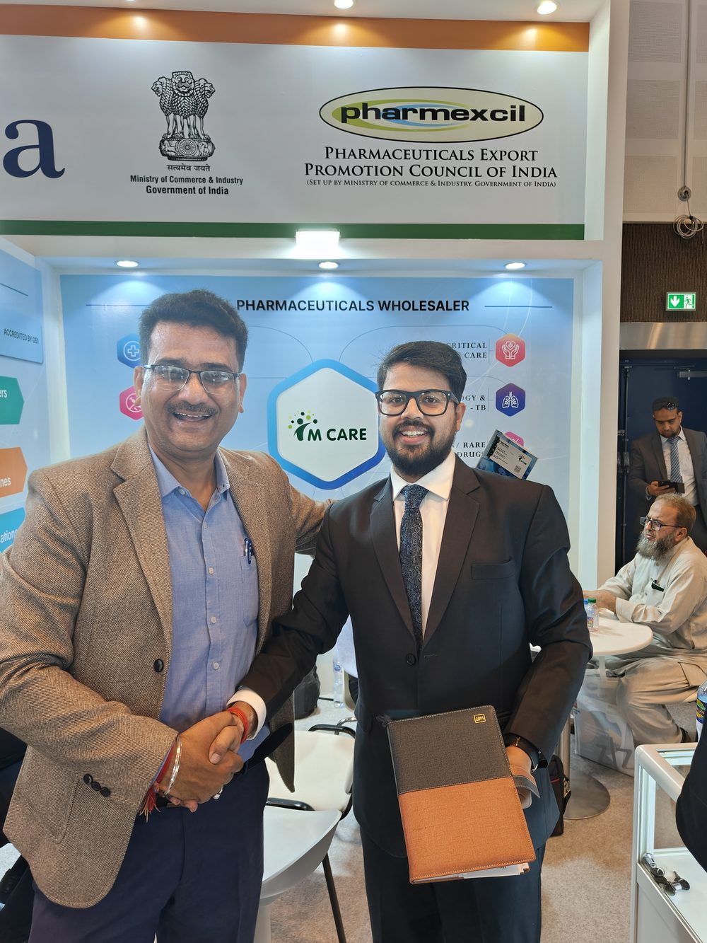 M Care Arab Health 2024 booth, meeting table with buyer documentation.