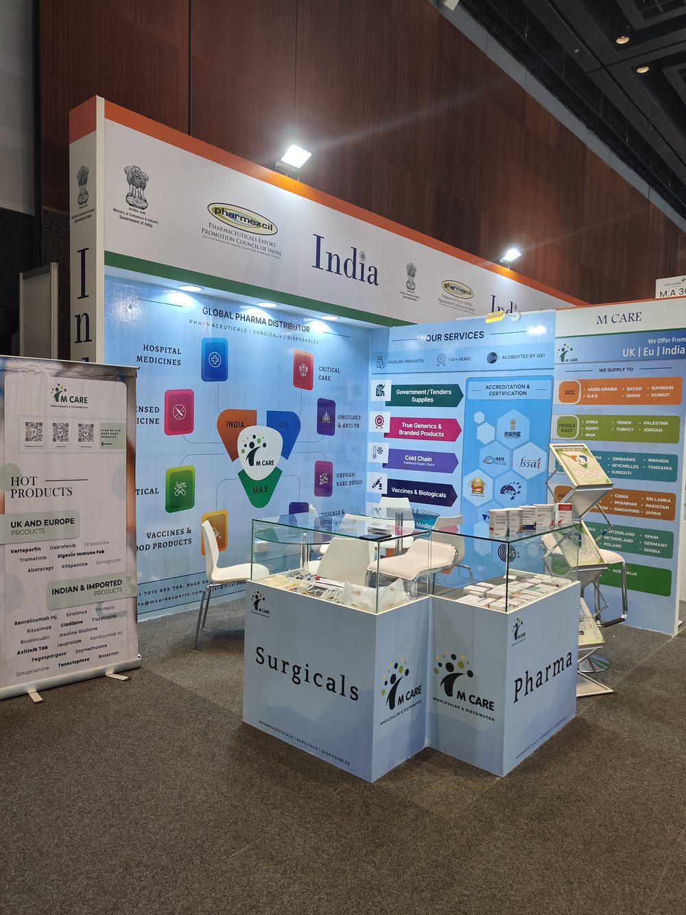 M Care Arab Health 2025 booth, category tiles, team in conversation with buyer.